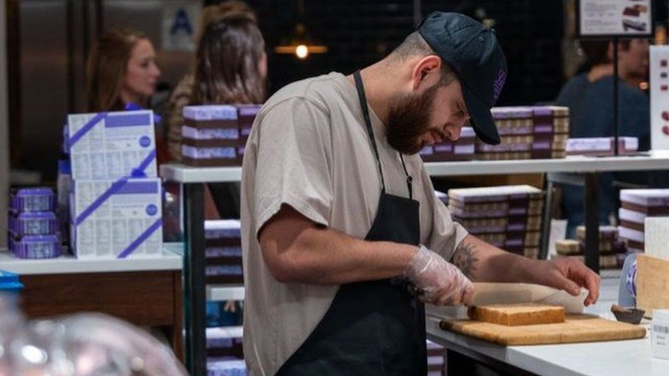 A man makes deserts at a store at Chelsea Market in Manhattan on February 02, 2024 in New York City.