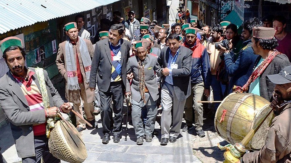 Shyam Saran Negi makes his way to the polling station in India's 2019 general election