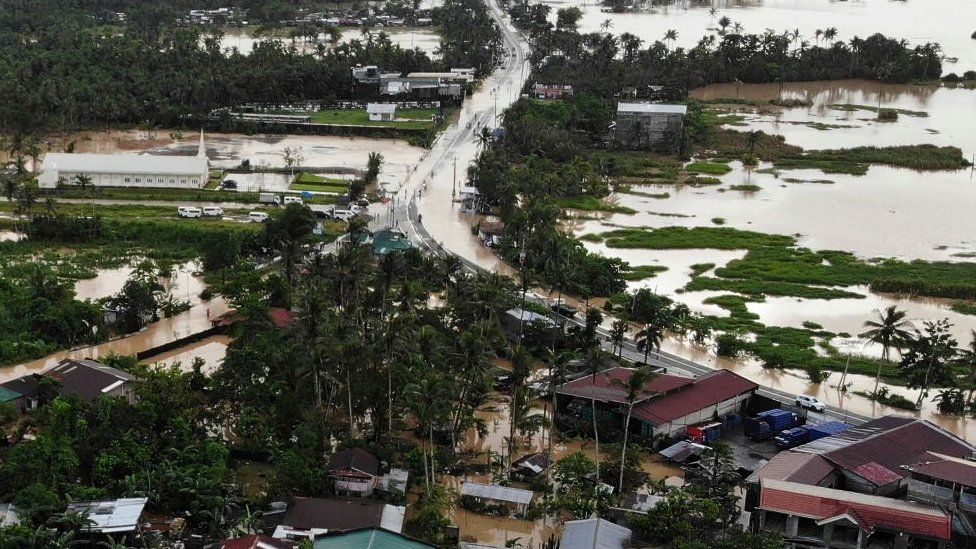 An aerial photo shows highway and houses submerged by flood waters in Abuyog town, Leyte province, southern Philippines, on April 11, 2022