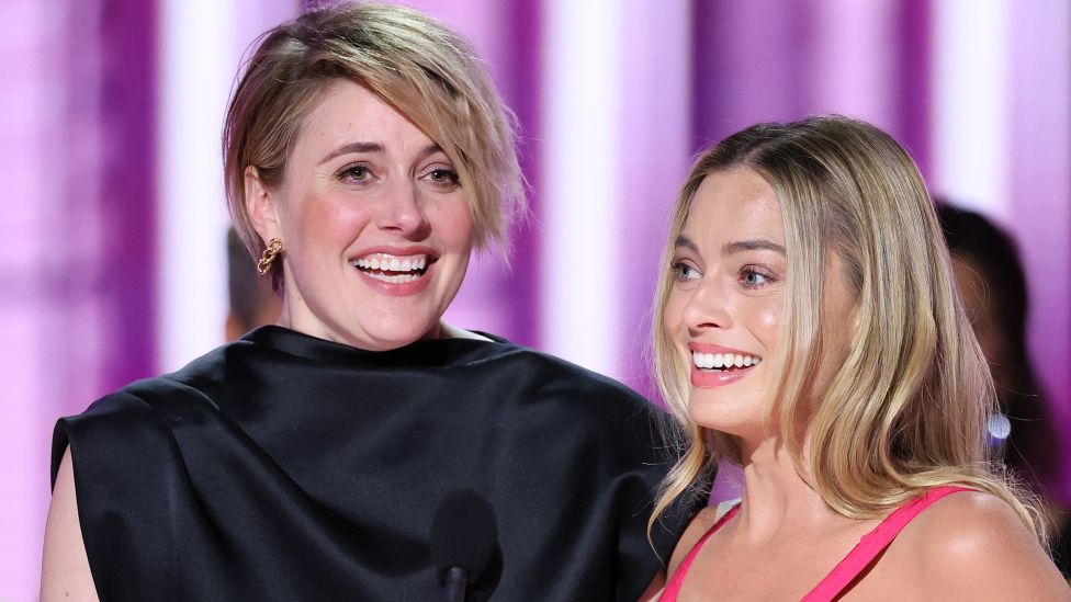 Greta Gerwig and Margot Robbie accepts the award for Cinematic and Box Office Achievement for "Barbie" at the 81st Golden Globe Awards held at the Beverly Hilton Hotel on January 7, 2024 in Beverly Hills, California