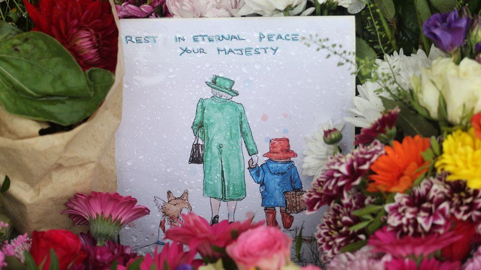 Flowers and Paddington Bear-themed tributes at The Long Walk gates in front of Windsor Castle