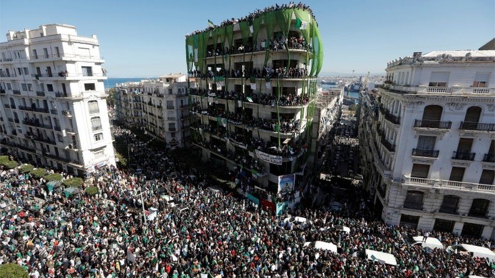 People gather during a protest over President Abdelaziz Bouteflika"s decision to postpone elections and extend his fourth term in office, in Algiers, Algeria March 15, 2019