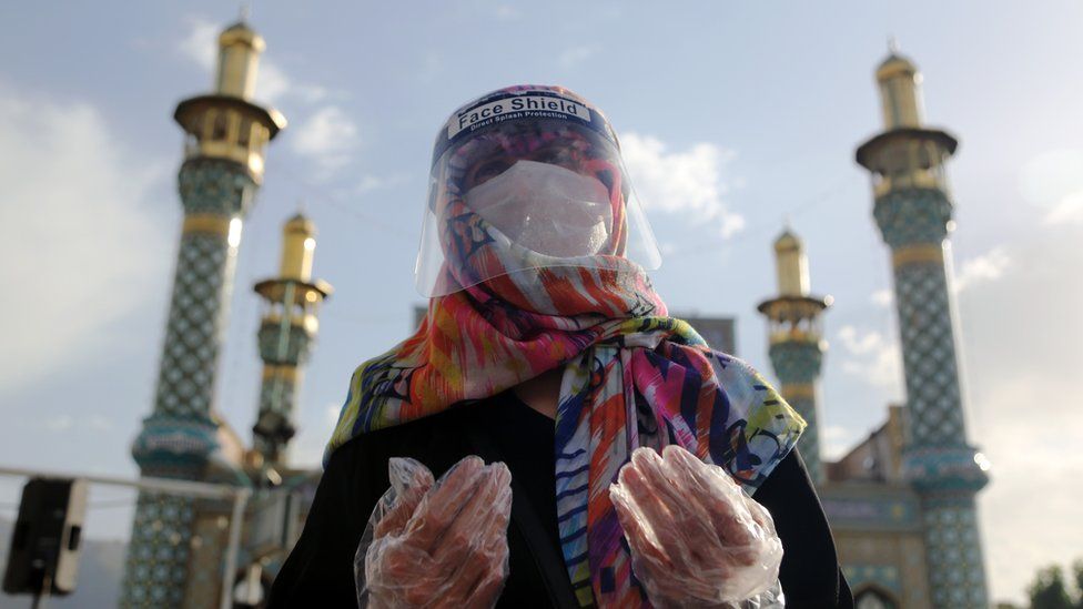 A worshipper in Tehran, Iran wears protective equipment