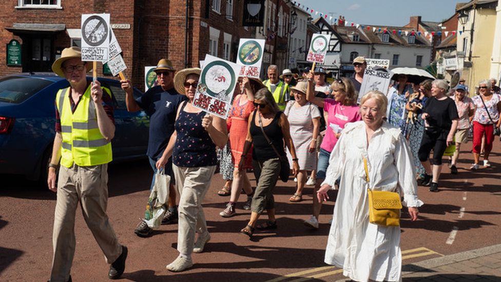 Protestors walking down a street