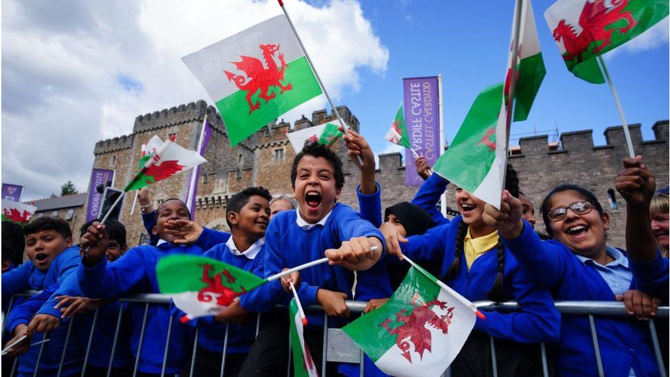 Children cheering with Welsh flags