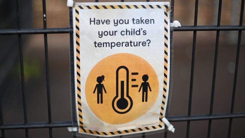 Sign at a school reading 'Have you taken your child's temperature?'