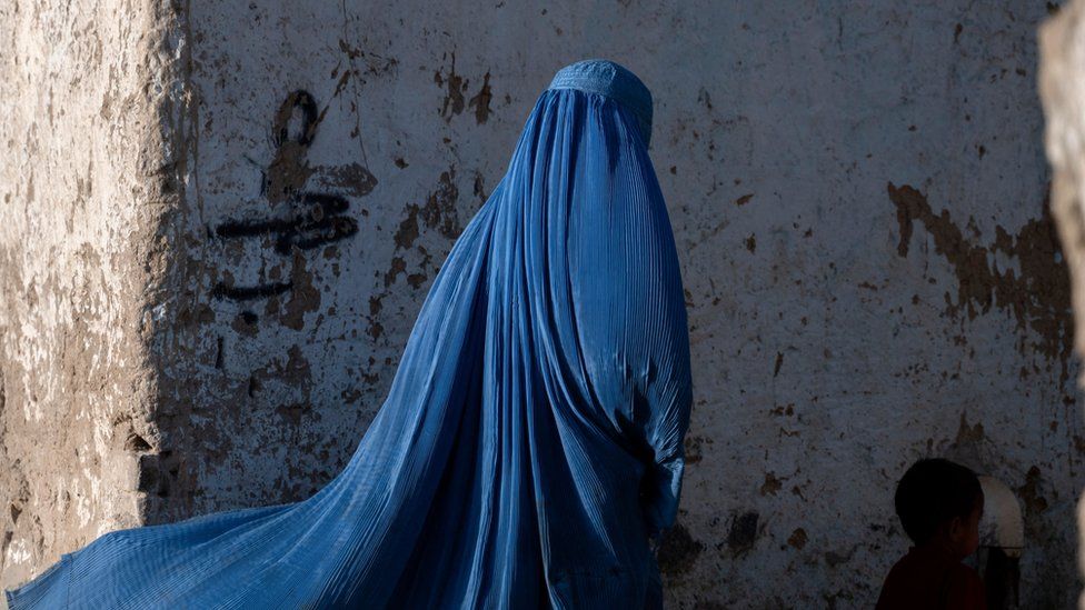 Afghan woman wears a blue burqa