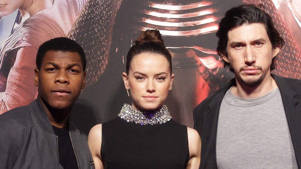 John Boyega, Daisy Ridley and Adam Driver - who star in Star Wars: The Force Awakens