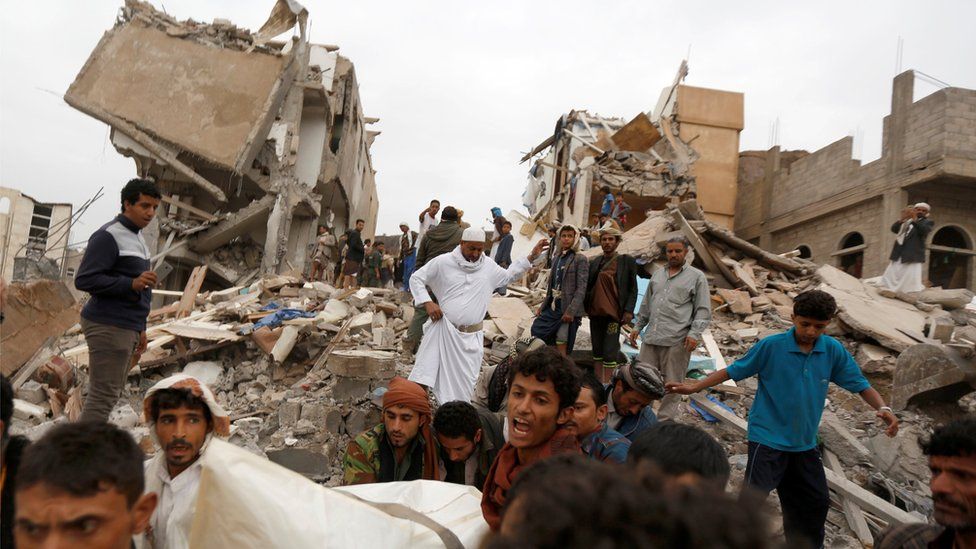 People carry the body of woman they recovered from under the rubble of a house destroyed by a Saudi-led air strike in Sanaa, Yemen (August 25, 2017)