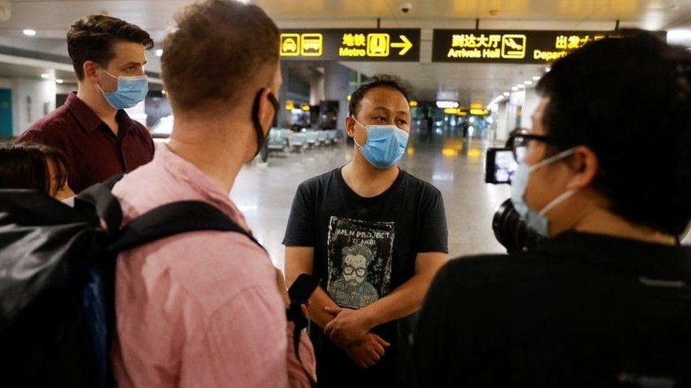 A colleague of one of the passengers on board speaks to reporters at Guangzhou International Airport