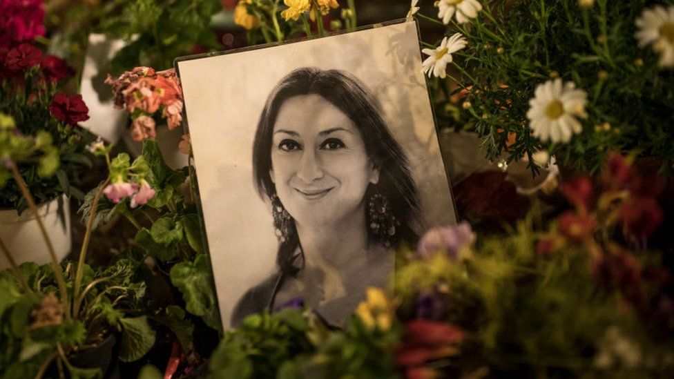 Flowers and tributes for Daphne Caruana Galizia left at a monument in Malta in March 2018