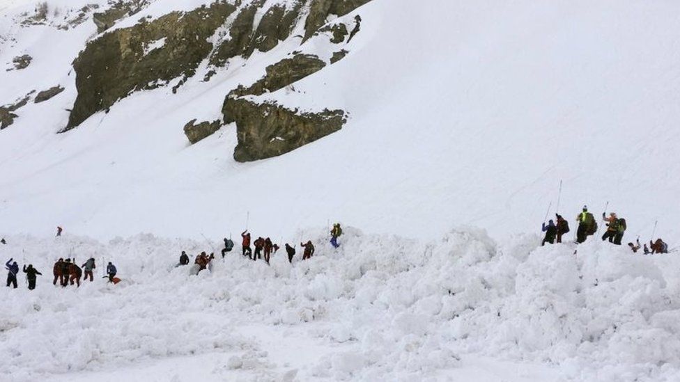 Rescuers combing through piles of snow