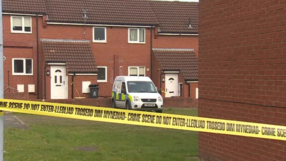 Police tape near the house in Wrexham where a body was found