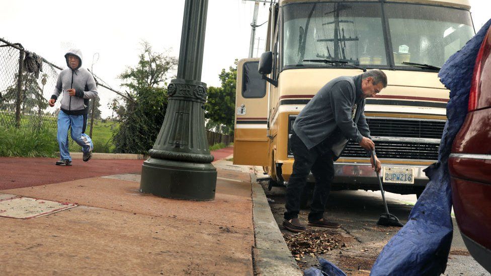 People tidy up outside their motorhome