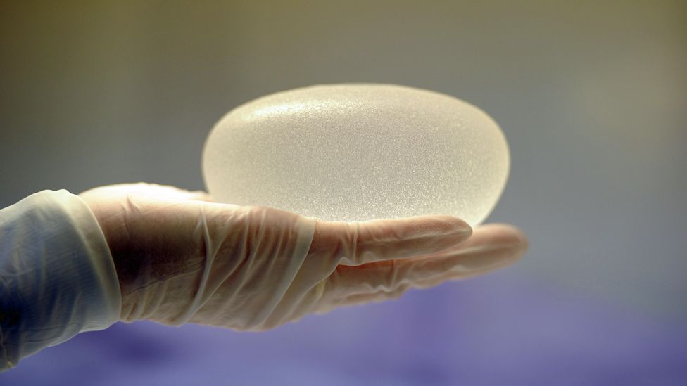 A technician presenting a silicone breast implant produced by French implant manufacturer, Sebbin laboratories