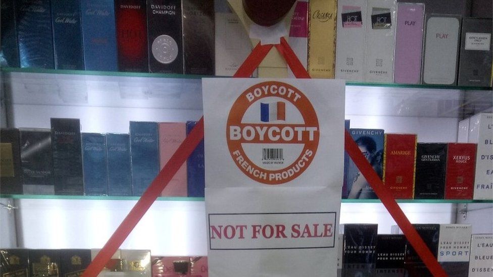 A boycott sign is placed on a showcase displaying French products at a store, in protest against the cartoon publications of Prophet Mohammad in France, in Karachi, Pakistan October 31, 2020.