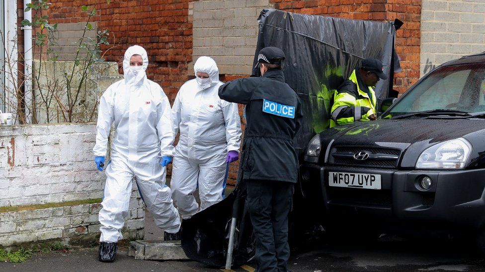 Forensic officers outside the alleyway