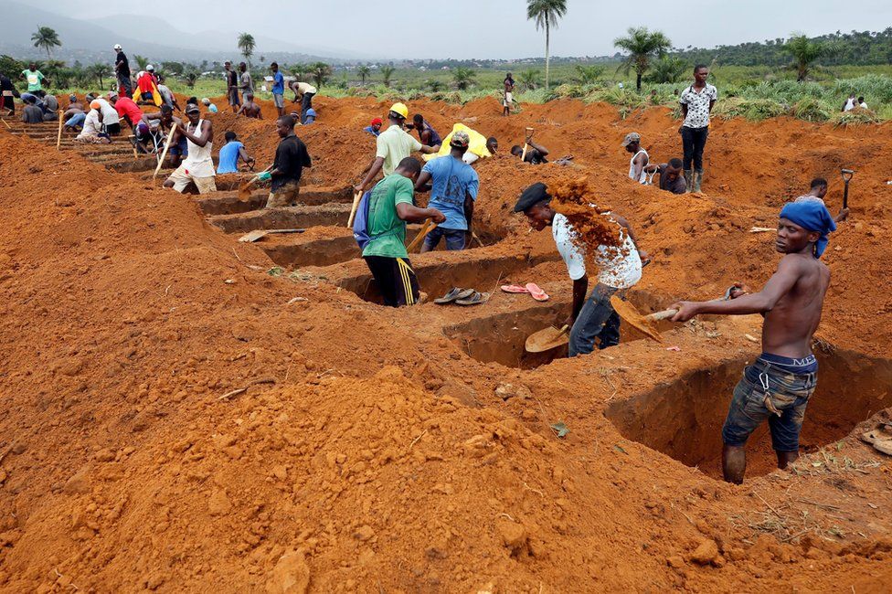 Workers are seen digging graves at Paloko cemetery in Waterloo, Sierra Leone August 17, 2017.