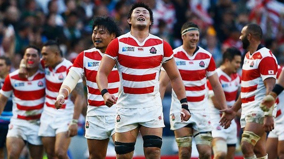 Japan players celebrate victory over South Africa in the Rugby World Cup