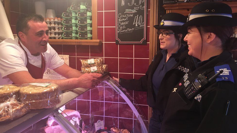 Two Gwent Police CSO's chat with a butcher at his shop