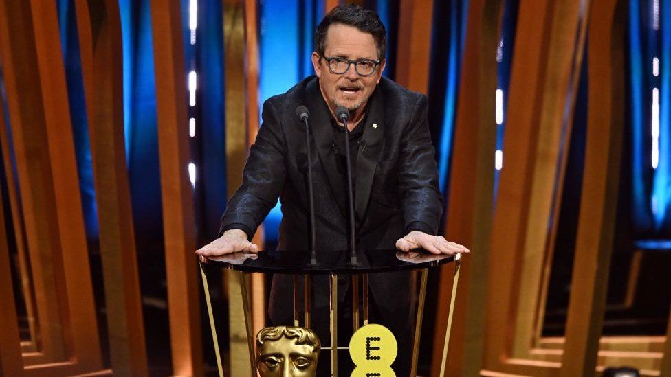 Michael J Fox presents the Best Film Award on stage during the EE BAFTA Film Awards 2024 at The Royal Festival Hall