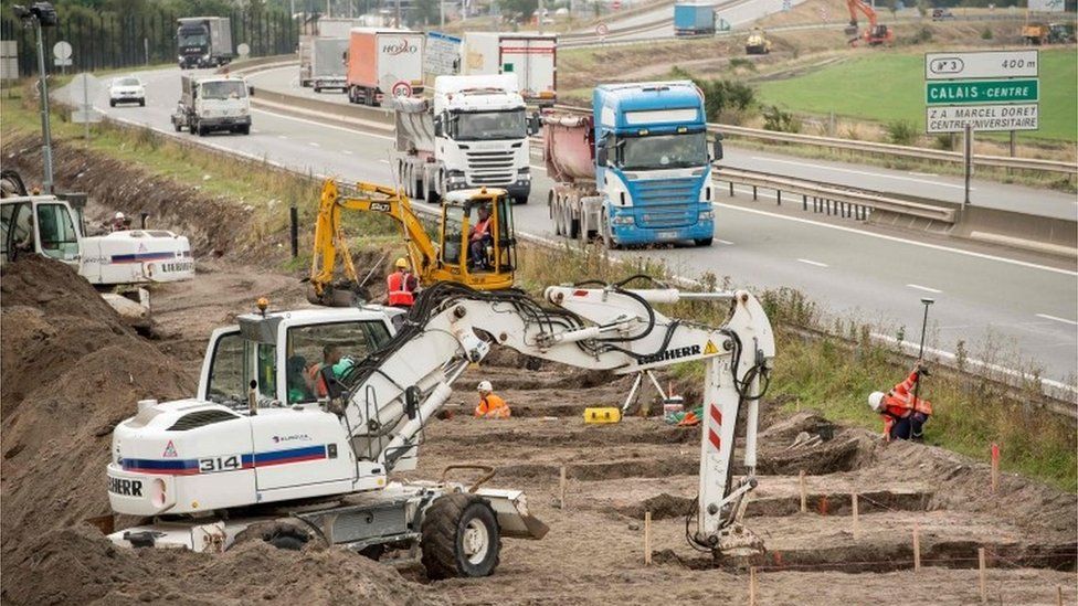 Diggers working on the foundations of the Calais wall