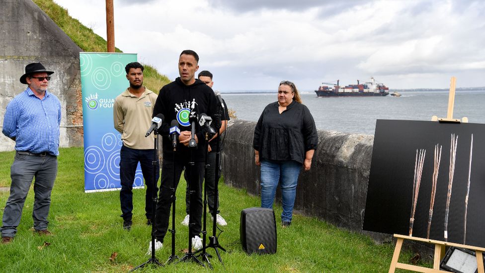 Representatives of the local Aboriginal land council in Sydney hold a press conference at Botany Bay with pictures of the returning spears