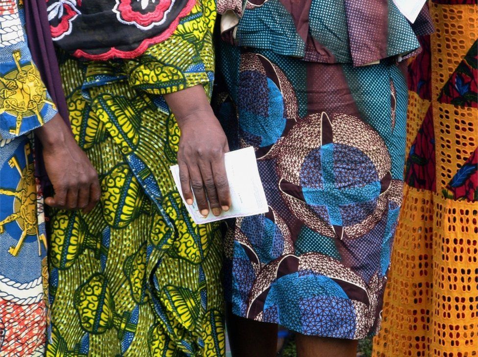 Women wait to cast their ballots at a polling station during the Guinea"s presidential election in Fria, Guinea October 18, 2020.