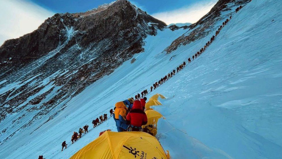 This photograph taken on May 31, 2021 shows mountaineers lined up as they climb a slope during their ascend to summit Mount Everest (8,848.86-metre), in Nepal