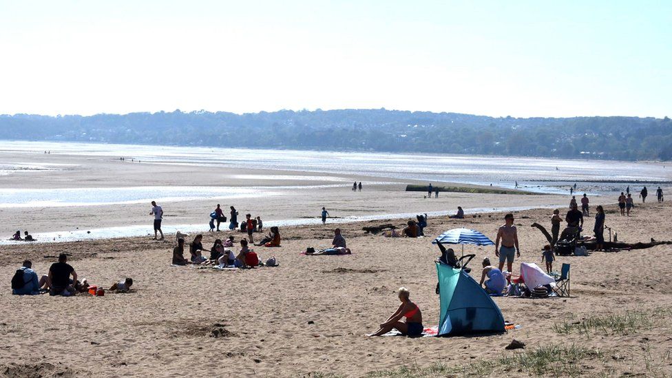 Sunbathers in Swansea Bay