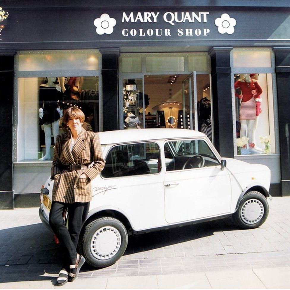 Mary Quant standing by her designer Mini