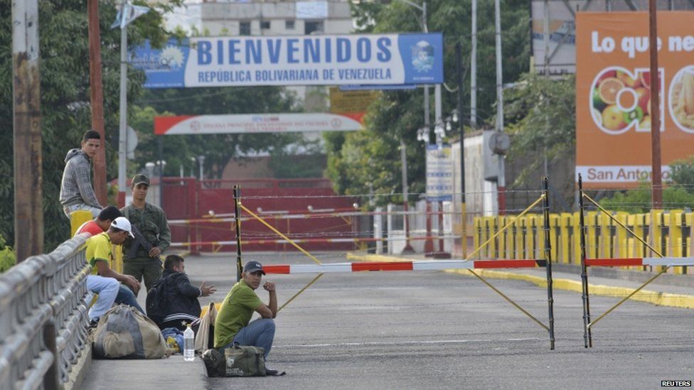 Venezuelans wait in the border at Simon Bolivar international bridge near the city of Cucuta, Colombia
