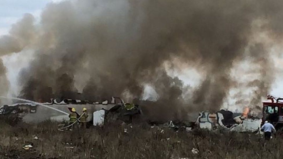 A handout photo made available by the Civil Protection State Coordination (CPCE) shows emergency personnel at the site where an Aeromexico plane crashed, in Durango, Mexico, 31 July 2018.