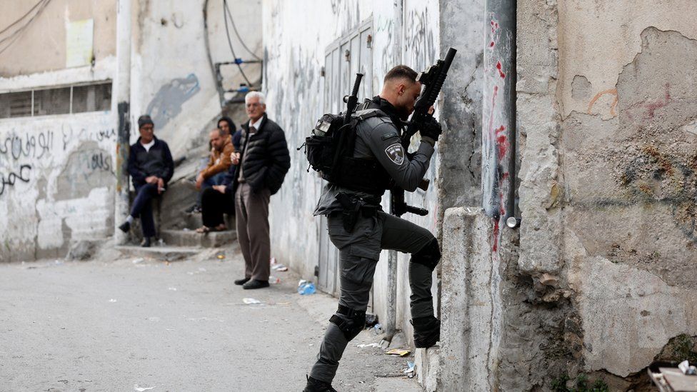 An Israeli Border police officer walks into a house in East Jerusalem
