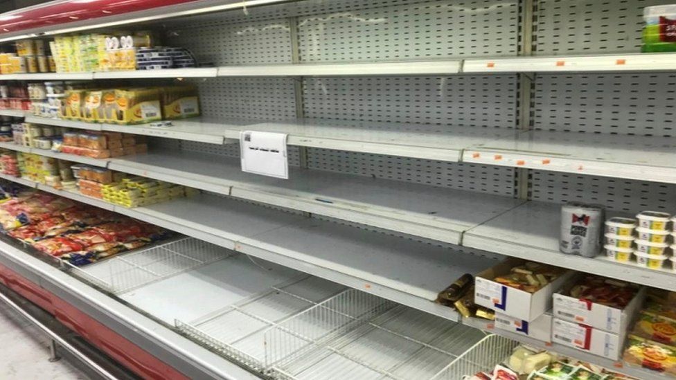 Empty shelves are seen where French products were displayed at Kuwaiti supermarkets