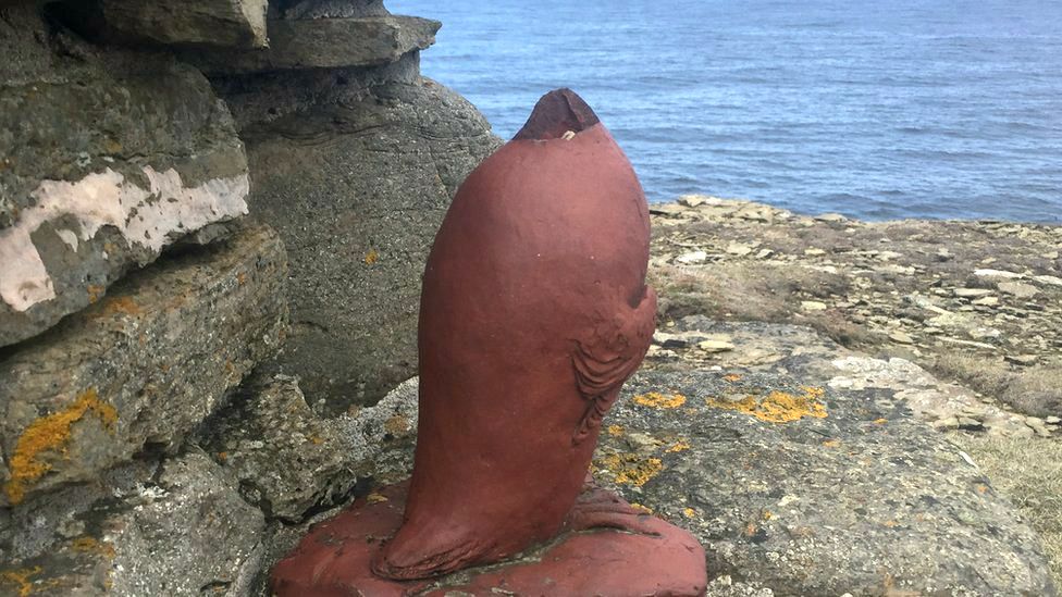 headless great auk statue