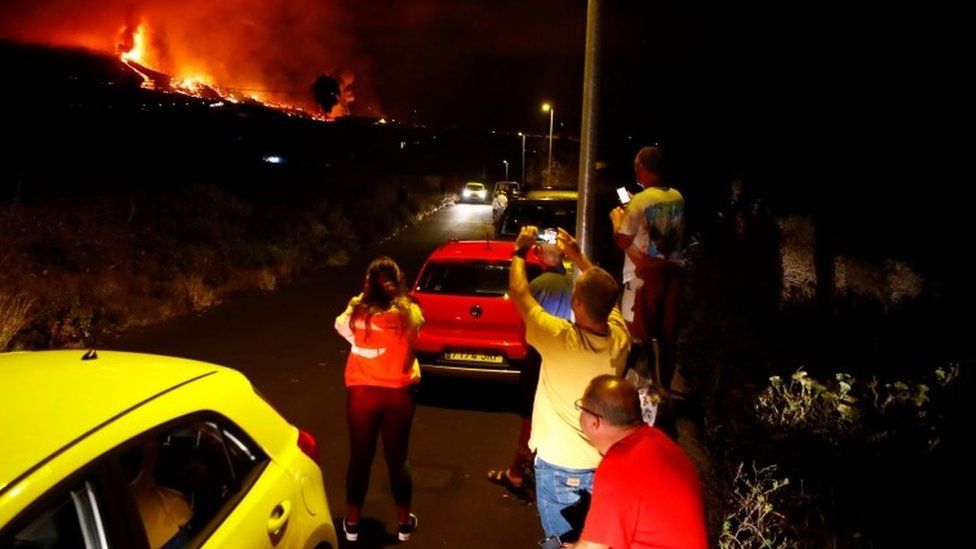 Residents watch lava following the eruption of a volcano in the Cumbre Vieja national park at El Paso, on the Canary Island of La Palma