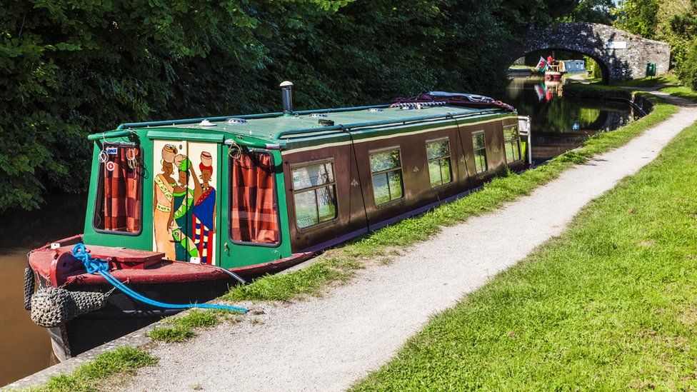 Monmouthshire and Brecon Canal with painted narrowboat moored to tow path