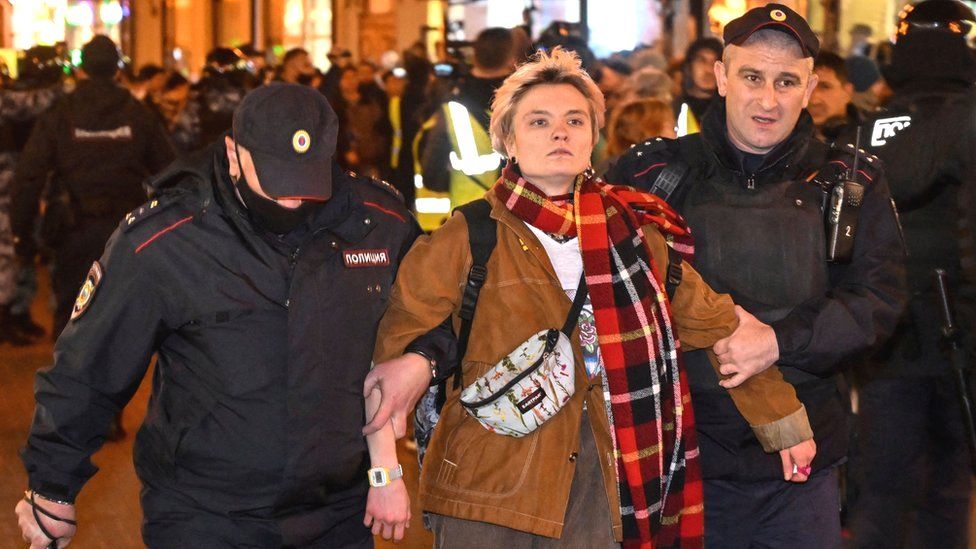 Police officers detain a woman in Moscow on 21 September 2022, following calls to protest against partial mobilisation announced by President Vladimir Putin