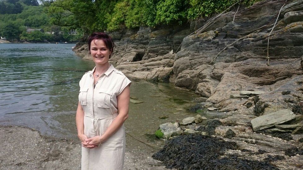 Dr Joanie Willett standing by a lake