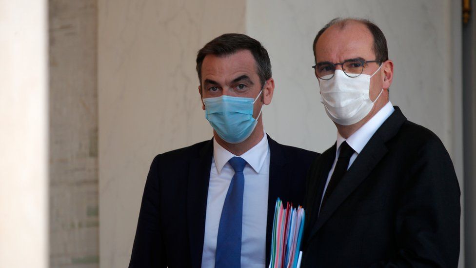 French Prime Minister Jean Castex and Health Minister Olivier Veran, wearing protective face masks, leave following the weekly cabinet meeting