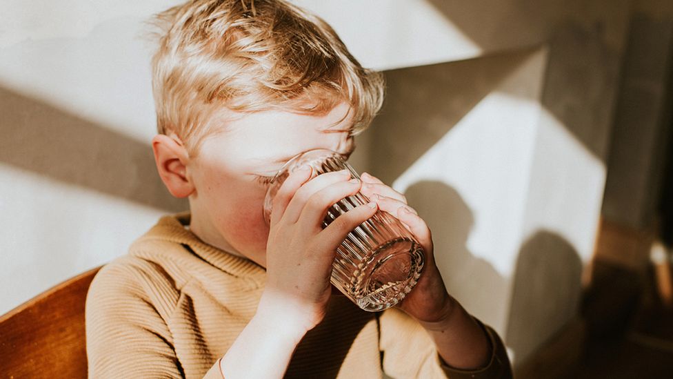 Boy drinking a solid  of water