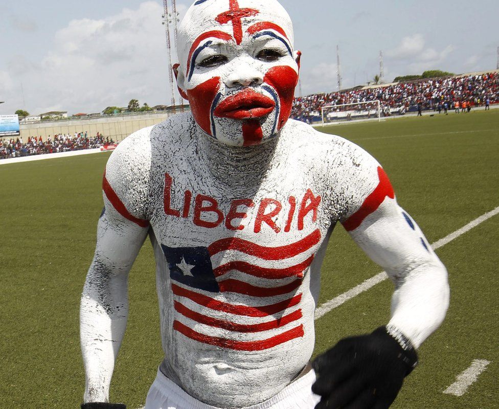 A painted Liberian football fan in Monrovia, Liberia - Friday 13 November 2015