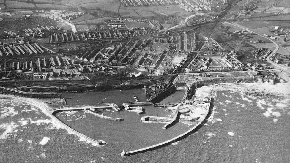 Aerial black and white view of Seaham harbour with the town beyond