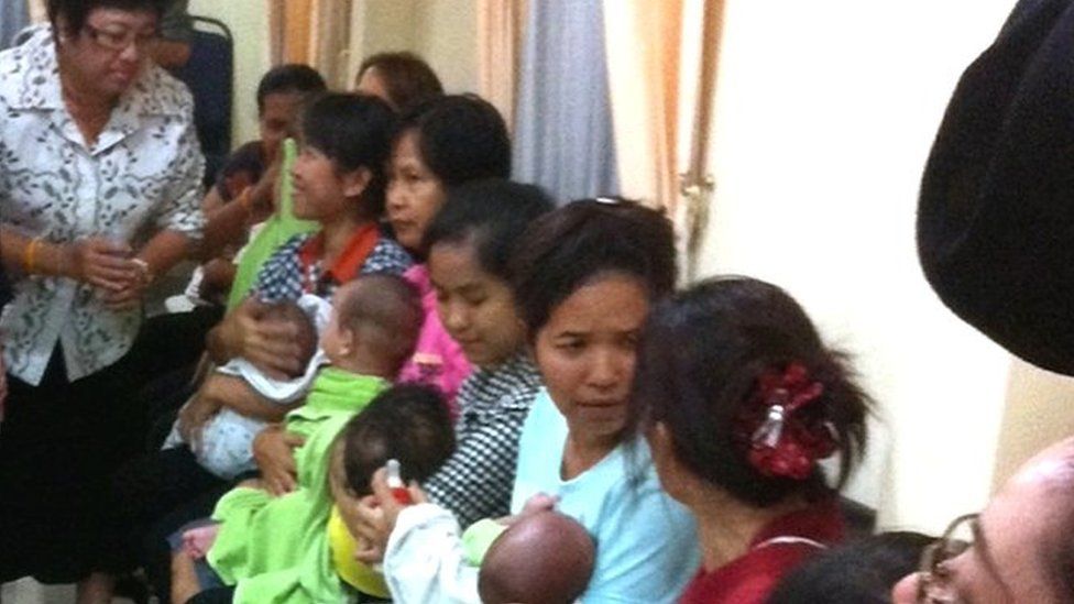 Thai nannies holding nine suspected surrogate babies after a police raid at a residential apartment on the outskirts of Bangkok, Thailand, 5 August 2014