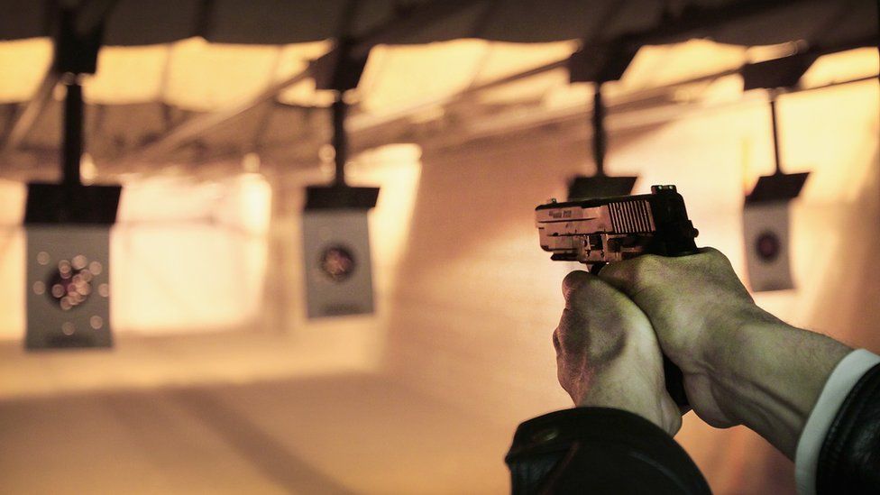 A man shoots at a target at a shooting range during a class to qualify for a concealed carry permit, 14 February 2014