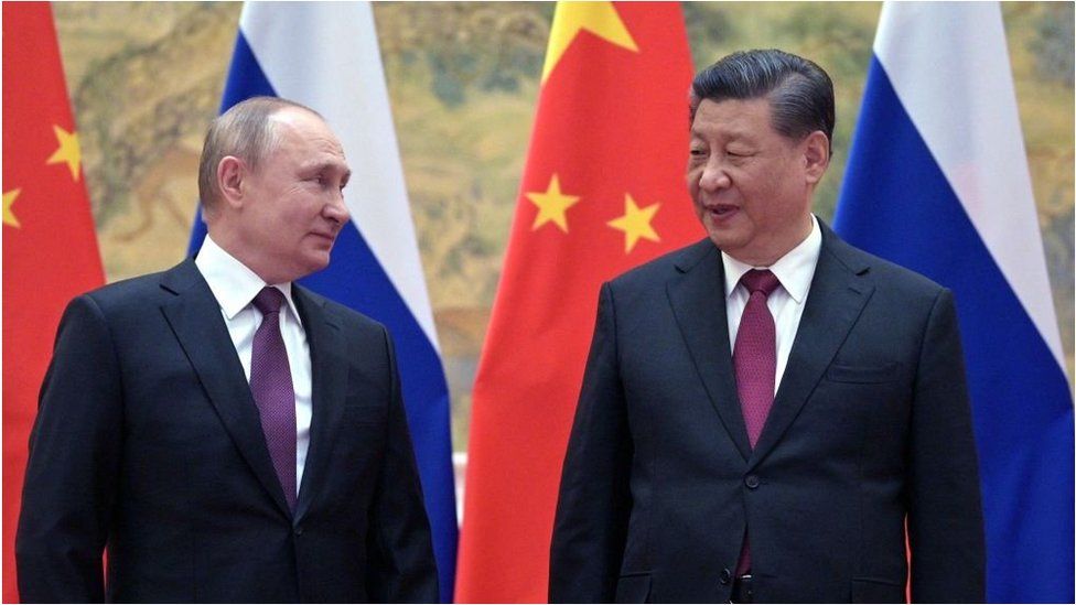 Russian President Vladimir Putin (L) and Chinese President Xi Jinping pose for a photograph during their meeting in Beijing, on February 4, 2022