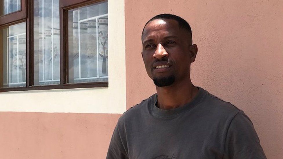 Jason Ipinge in front of his two-bedroom flat