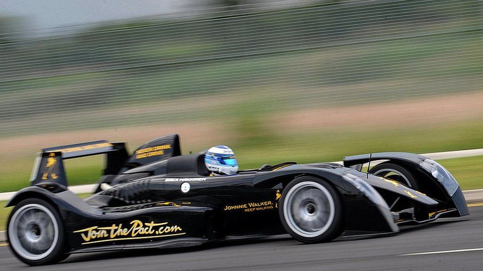 Twice Formula One world champion driver Mika Hakkinen of Finland drives a high performance two seater Johnnie Walker super car in Singapore on September 21, 2009
