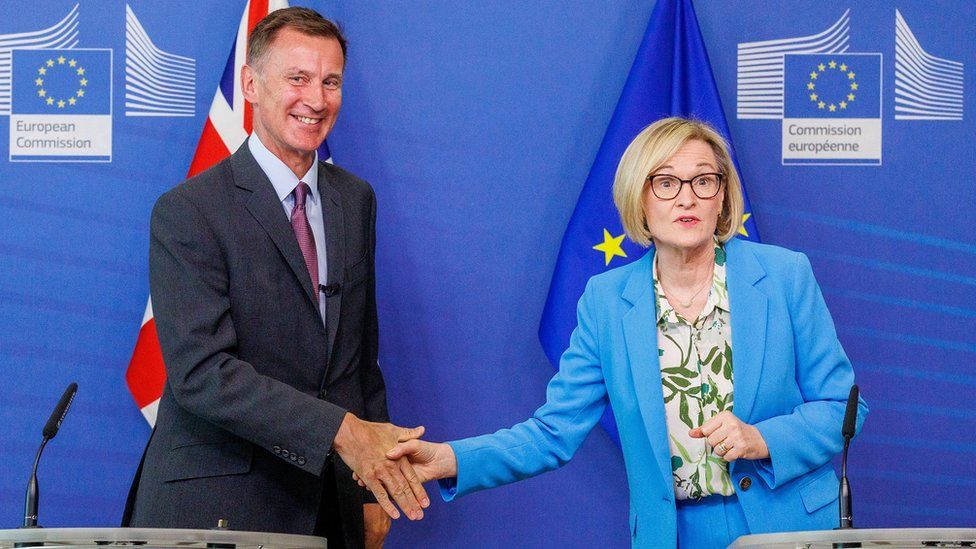 Chancellor Jeremy Hunt (L) and EU Commissioner for Financial Stability, Financial Services and Capital Markets Union Mairead McGuinness shake hands after signing the EU-UK Memorandum of Understanding on financial services regulatory cooperation